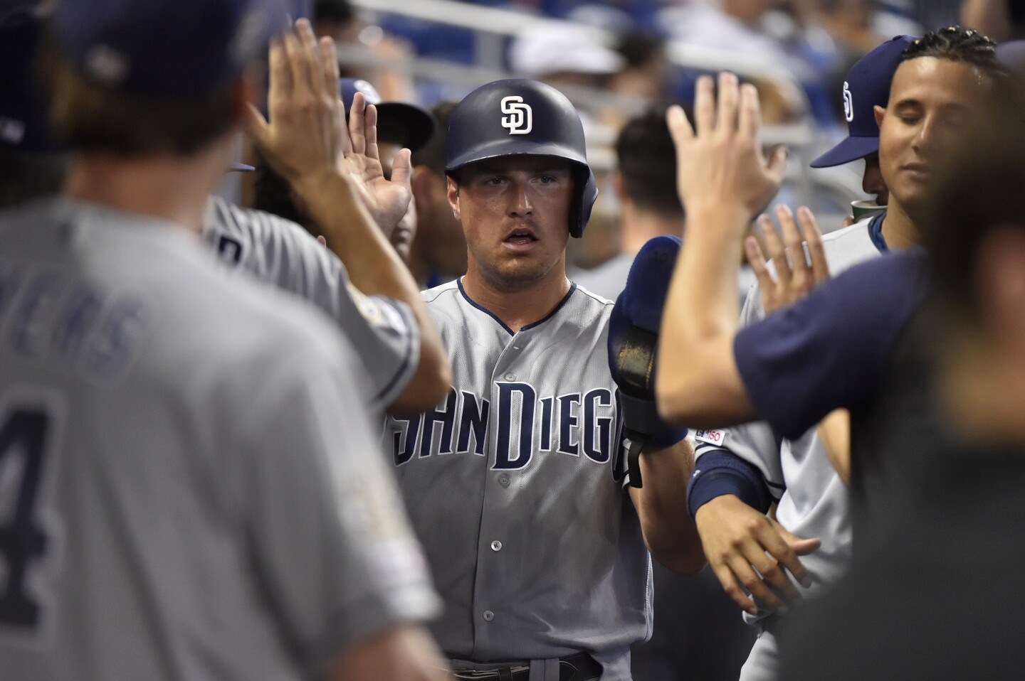 MIAMI, FL - JULY 18: Hunter Renfroe #10 of the San Diego Padres is congratulated by teammates after scoring in the first inning against the Miami Marlins at Marlins Park on July 18, 2019 in Miami, Florida. (Photo by Eric Espada/Getty Images) ** OUTS - ELSENT, FPG, CM - OUTS * NM, PH, VA if sourced by CT, LA or MoD **