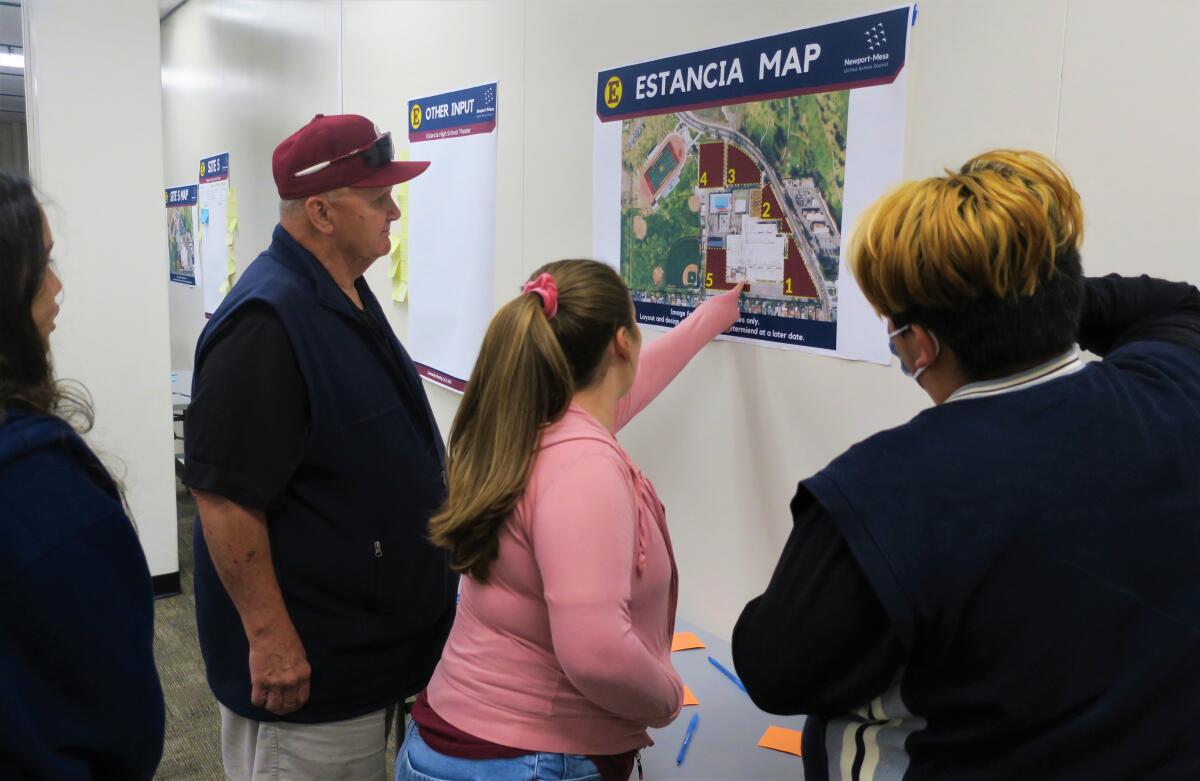 Estancia High junior Sofia Kehoe, center, Thursday points to one of five sites being considered for a new theater.