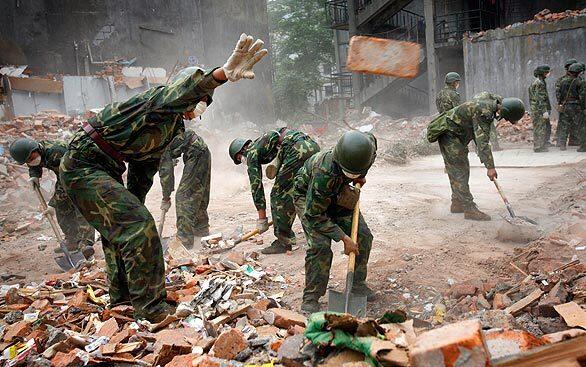Chinese soldiers clear rubble in the earthquake-hit township of Hanwang in Mianzhu city, north of Chengdu in Sichuan province.