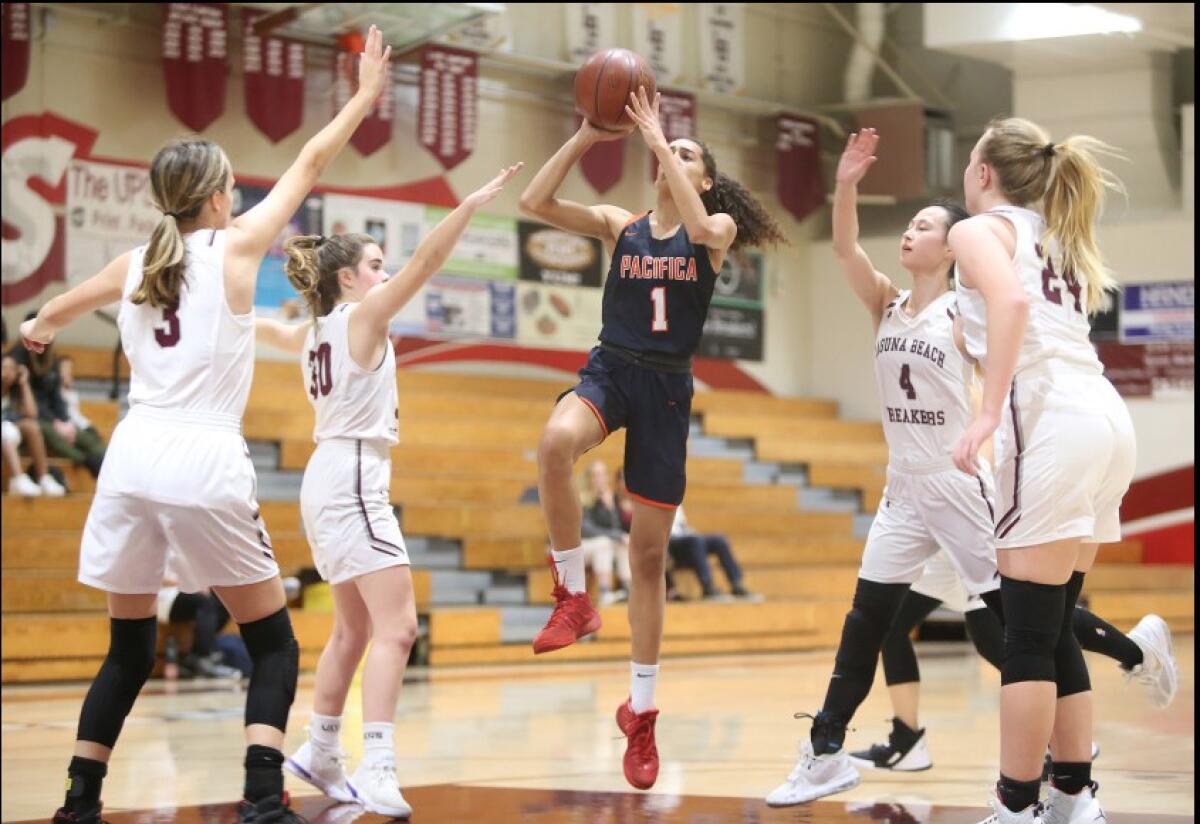 Pacifica Christian Orange County’s Charis Wondercheck takes a running jumper while surrounded by Laguna Beach defenders.
