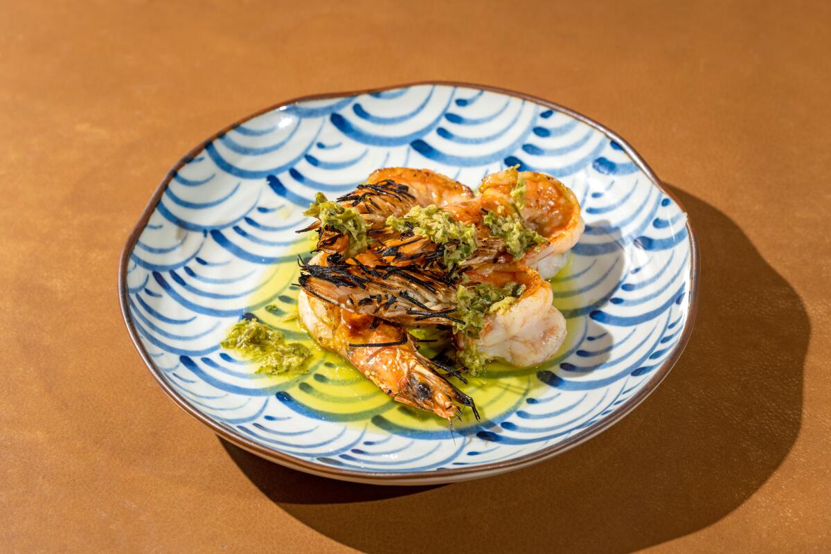 Seafood served on a white plate with blue decoration.