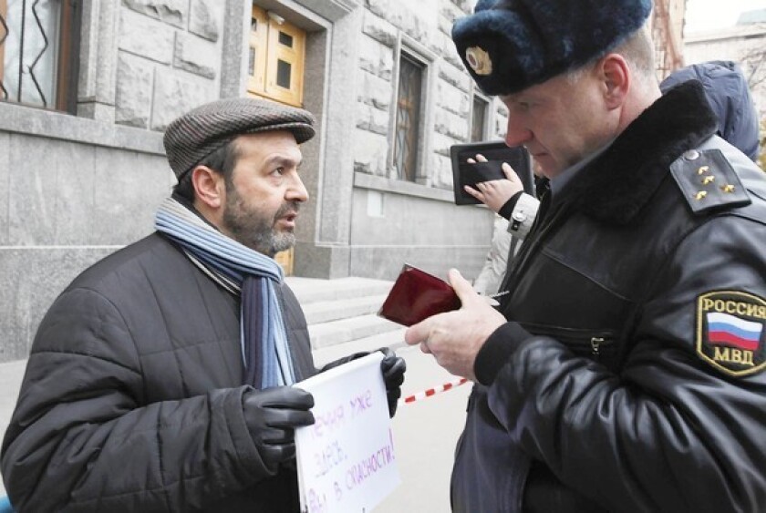 Writer Viktor Shenderovich speaks to a Russian police officer outside the Federal Security Service, the successor agency to the KGB. Shenderovich was demonstrating in response to an activist's reported kidnapping and torture.