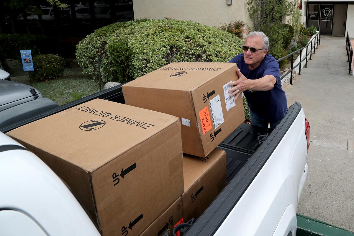 Daniel Bondarenko picks up boxes packed with surgical supplies.