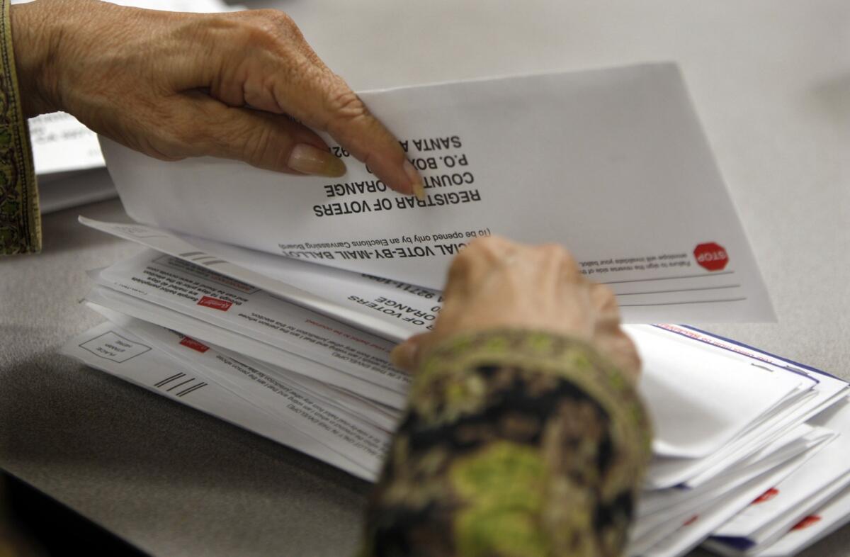 Mail-in ballots are counted in Santa Ana. A state Senate election next week shows the changed landscape of Orange County.