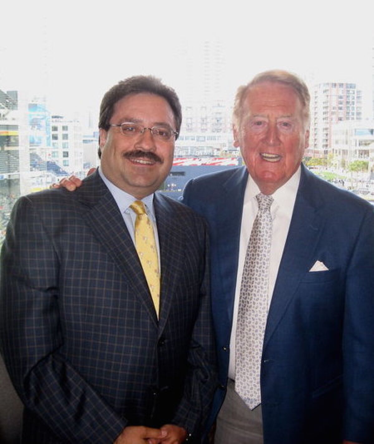 Michael Horowicz poses with Vin Scully in the broadcaster's booth in San Diego.