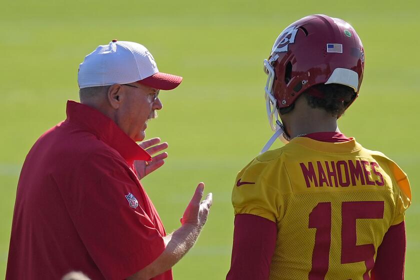 Chiefs head coach Andy Reid talks to quarterback Patrick Mahomes (15) during camp.