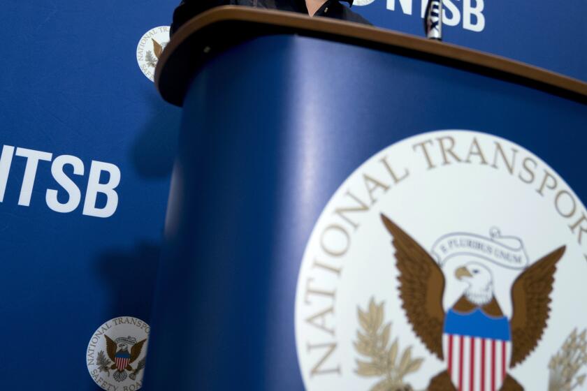 FILE - The National Transportation Safety Board logo and signage are seen at a news conference at NTSB headquarters in Washington, Dec. 18, 2017. Investigators said Thursday, June 6, 2024, that an incoming FedEx cargo plane came within less than 200 feet of hitting a Southwest Airlines jet last year in Austin, Texas, after both were cleared to use the same runway. (AP Photo/Andrew Harnik, File)