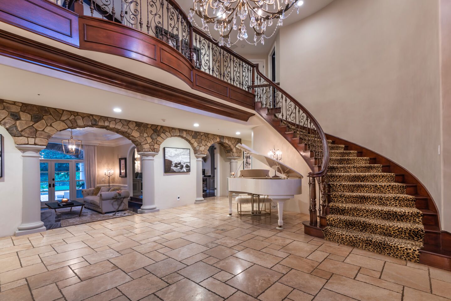 Leopard-print carpet and a white grand piano kick off the roughly 6,700-square-foot floor plan.