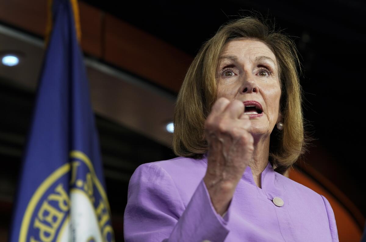Nancy Pelosi gesturing during a news conference