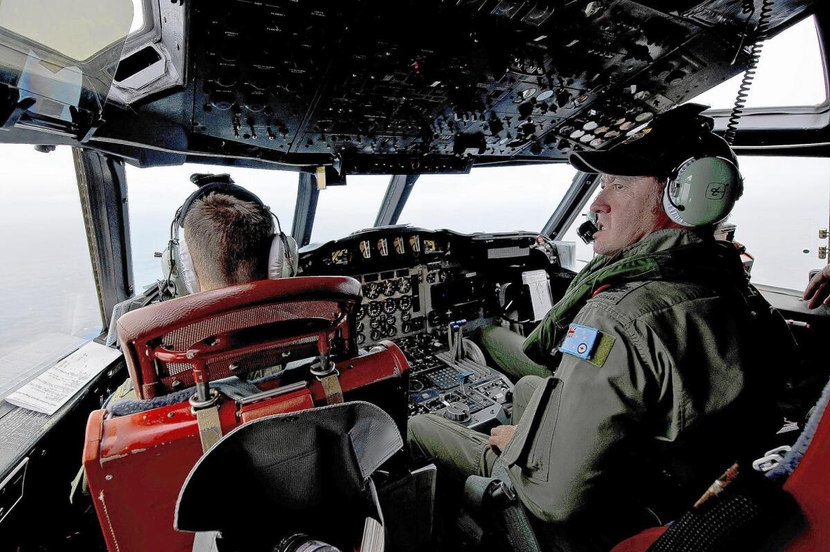 Members of Australia's air force look for debris from Malaysia Airlines Flight 370 in the southern Indian Ocean.