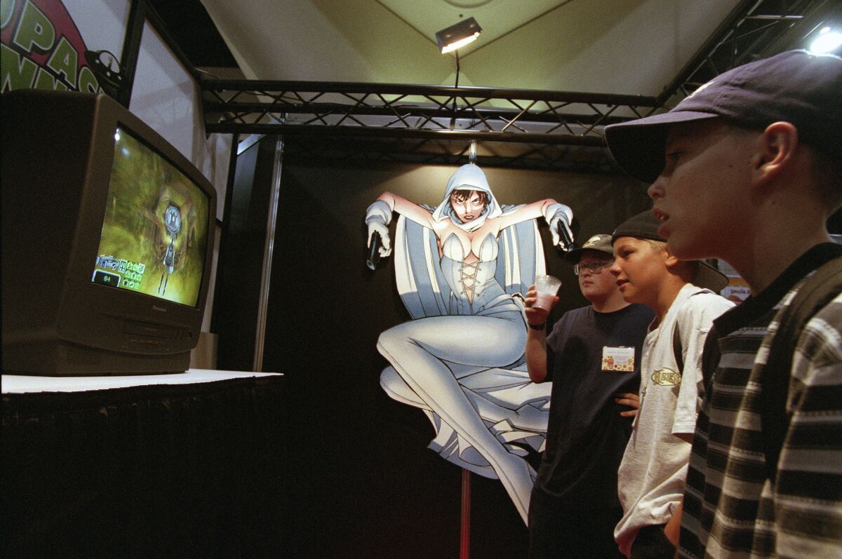 Vernon Lingley, left, Patrick Connors and Lance Tabor check out a video of "Space Bunnies" (which is also a comic book) at Comic-Con in 1998.