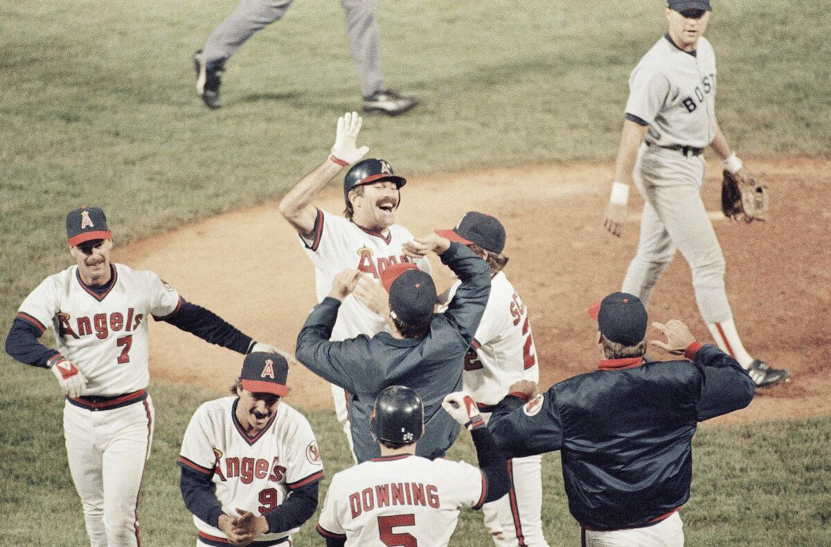 Angels' Bobby Grich, center, gets high fives from teammates after driving in the winning run during Game 4 of the 1986 ALCS. 