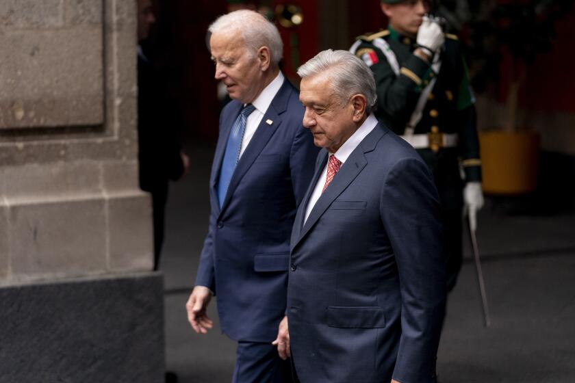 President Joe Biden walks with Mexican President Andres Manuel Lopez Obrador as he arrives at the National Palace in Mexico City, Mexico, Monday, Jan. 9, 2023. (AP Photo/Andrew Harnik)