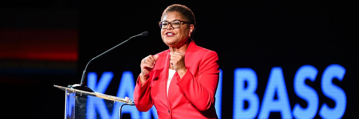 L.A. Mayor Karen Bass speaking at a lectern at a rally