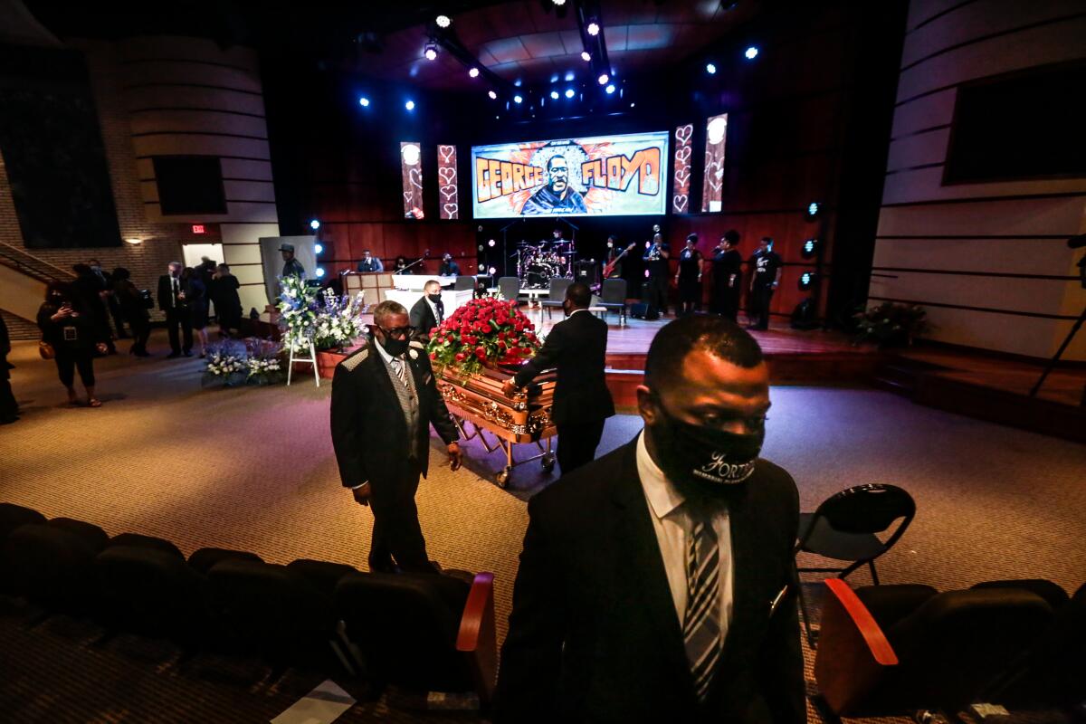 Funeral directors remove George Floyd's casket from a memorial service on June 4.