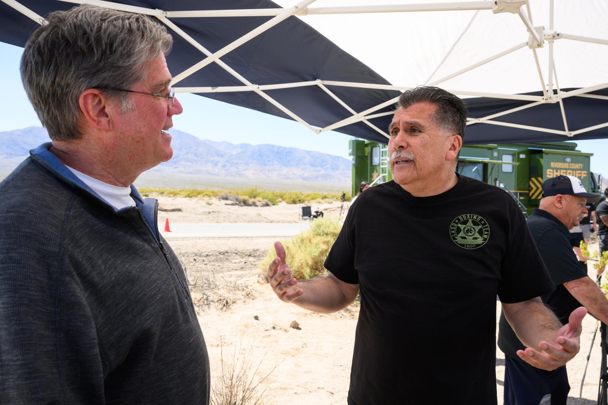 Los Angeles County Sheriff Robert Luna, right, talks to Sean Kennedy during the Baker to Vegas law enforcement relay.