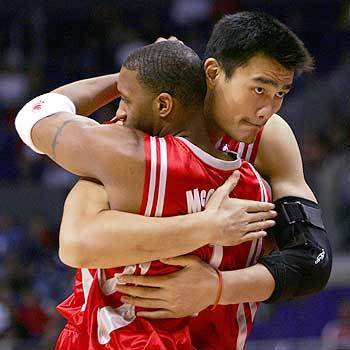 Houston Rockets' Yao Ming hugs teammate Tracy McGrady before the start of their game against the Los Angeles Clippers.