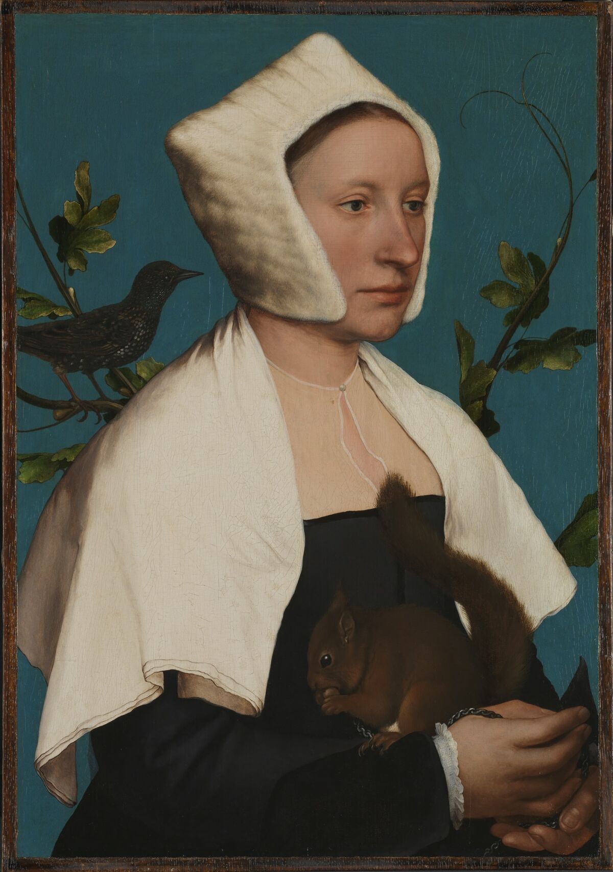 A woman in a painting with a bird on her shoulder and a squirrel in her hand.