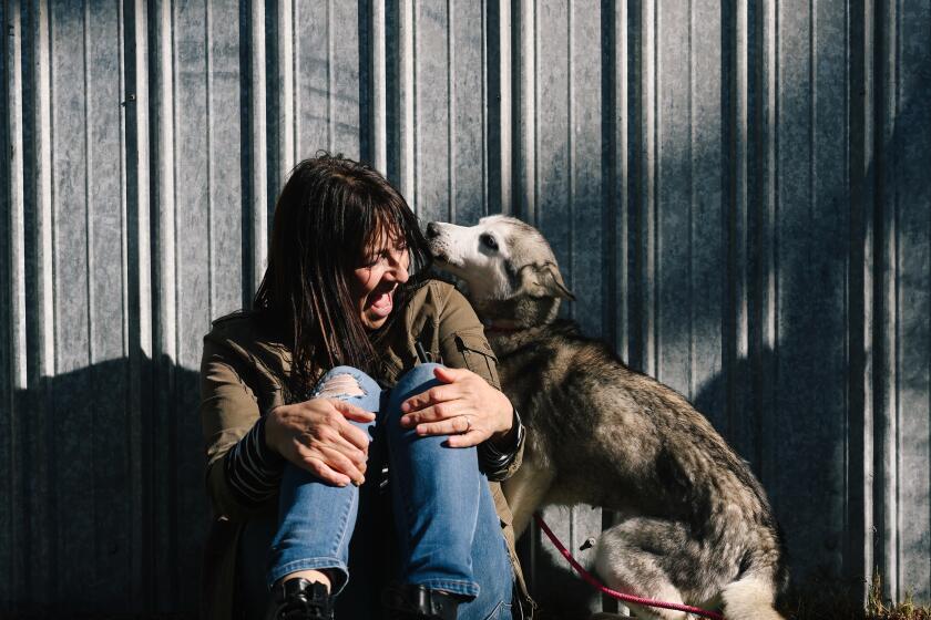 Lancaster, CA - January 21: Rita Earl Blackwell interacts with Missy at the Lancaster Animal Care Center.