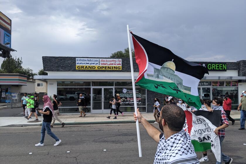 Pro-Palestine protesters march west on Main Street in El Cajon Sunday in response to the "We are Israel" rally. Some protesters engaged in scuffles with extremists just outside the rally.