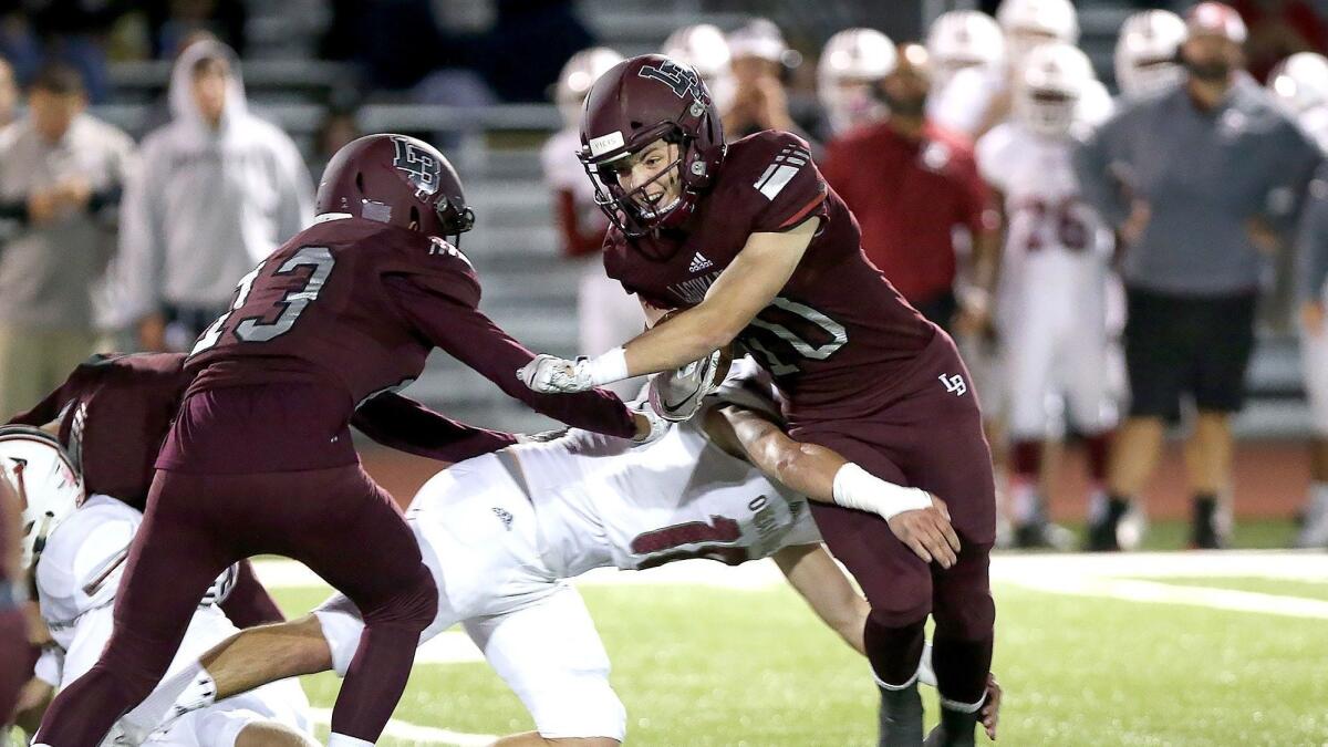 Laguna Beach High's Shane Lythgoe is tackled during a Pac 4 League game against visiting Ocean View on Friday.