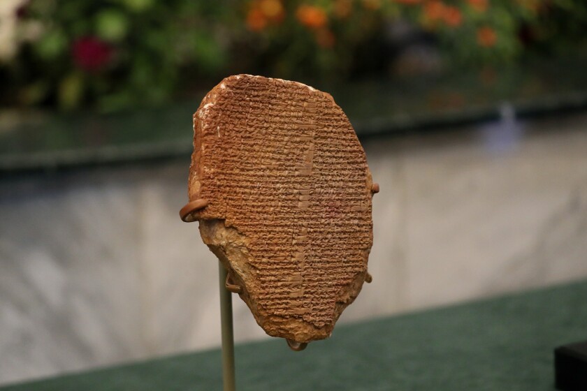 A recovered clay tablet from the United States is displayed at the Ministry of Foreign Affairs, Baghdad, Iraq, Tuesday, Dec. 7, 2021. The 3,500-year-old clay tablet bearing a portion of the Epic of Gilgamesh that was looted from an Iraqi museum 30 years ago was formally returned to Iraq Monday. (AP Photo/Khalid Mohammed)