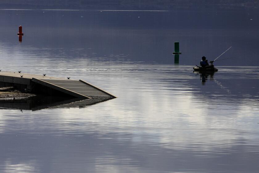 LAKE ELSINORE,, CA. MARCH 1, 2024: Float Fisherman Johnathan O. Skinner casts his line near one of the submerged docks at Launch Pointe on Lake Elsinore. After a series of heavy rainstorms hit Southern California, water levels at Lake Elsinore have risen to one of the highest marks in 25 years PHOTOS FOR THE TIMES BY MARK BOSTER ©Mark Boster.2024