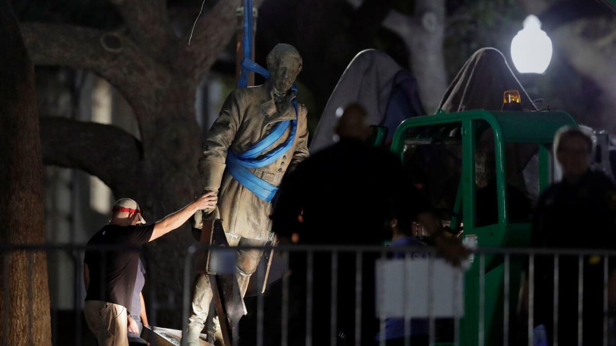 A statue of Confederate Gen. Robert E. Lee is removed from the University of Texas campus, early Monday morning in Austin, Texas.