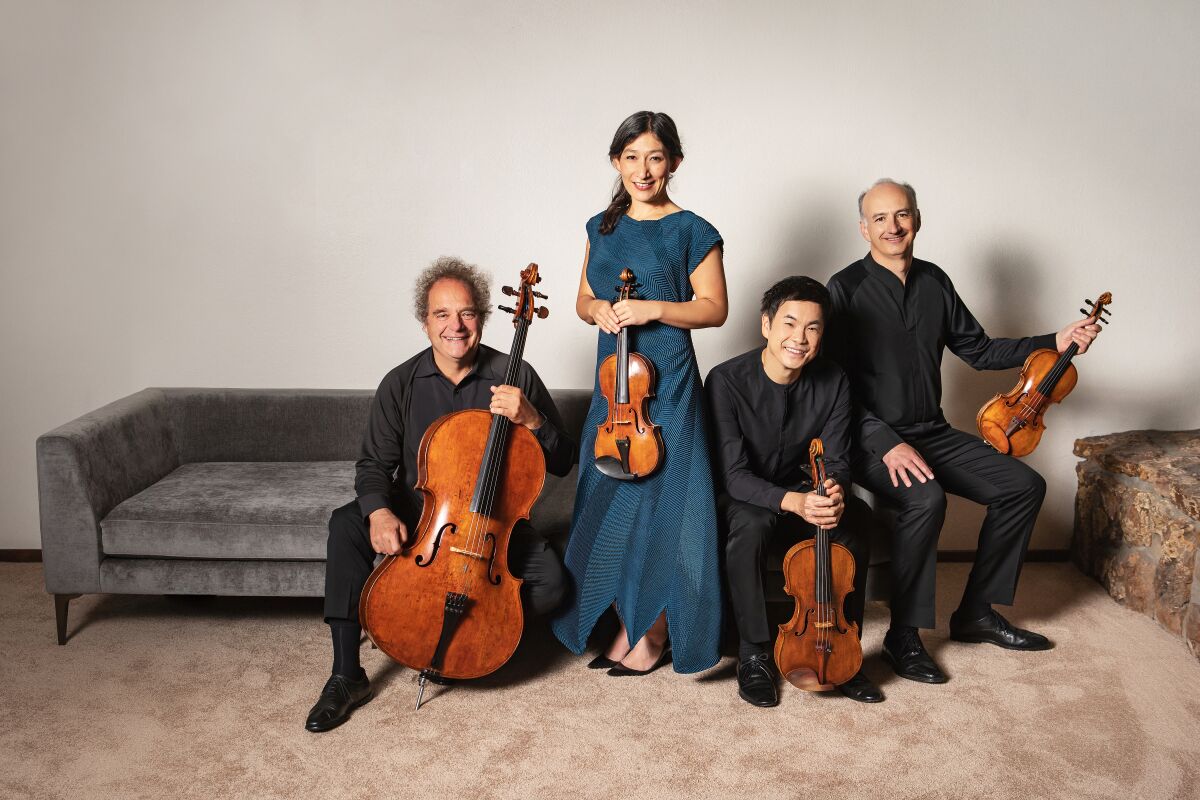 Members of a string quartet pose with their instruments