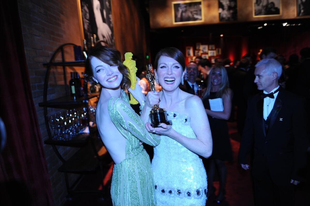 Emma Stone, left, and Julianne Moore at the 87th Academy Awards Governors Ball on Sunday at Hollywood & Highland center.