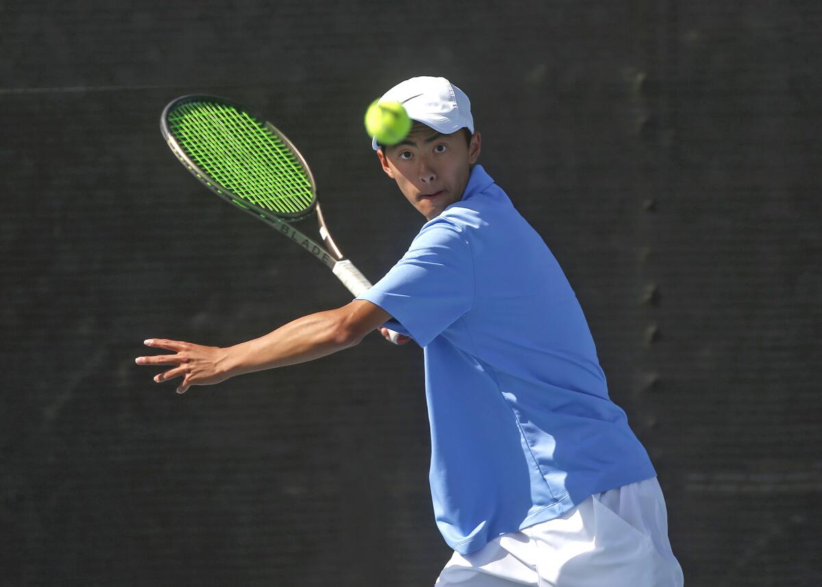 Ansel Lee of Corona del Mar eyes a forehand during a doubles match against Palos Verdes Peninsula on Wednesday.