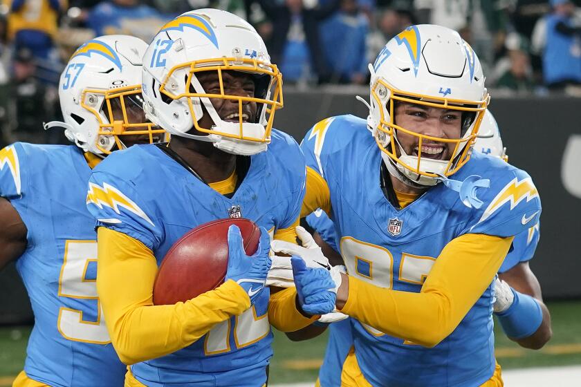 Los Angeles Chargers wide receiver Derius Davis, left, celebrates with teammates.