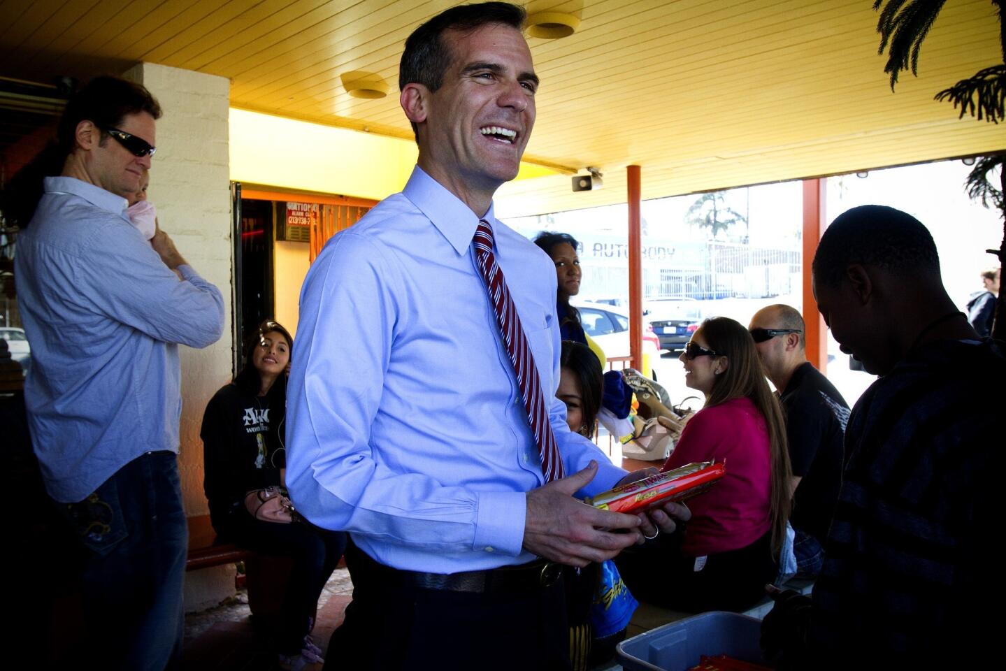 City Councilman Eric Garcetti buys candy from a student before having lunch at Roscoe's House of Chicken and Waffles on West Pico Boulevard.