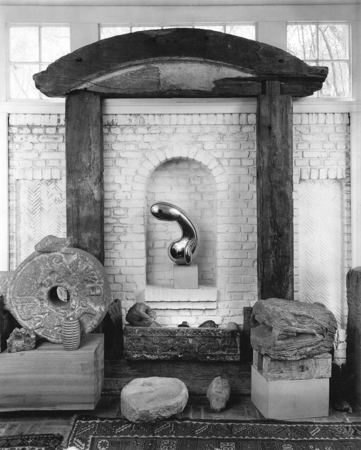 Constantin Brancusi's sculpture "Princess X" is surrounded by Aztec stone sculptures in the Arensbergs' foyer.