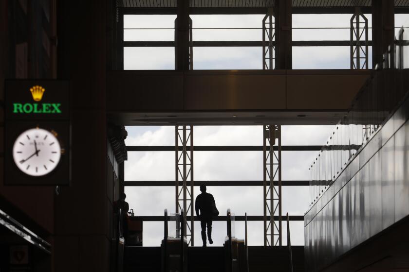 LOS ANGELES, CA - MARCH 24, 2020 - A lone traveler makes his way to catch a flight through in a sparse Tom Bradley International Terminal due to the coronavirus that has effected air travel at Los Angeles International Airport on March 24, 2020. (Genaro Molina / Los Angeles Times)