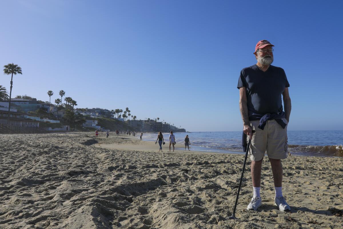 David Peck, 82, enjoys the view of the Laguna Beach shoreline Tuesday morning as the city reopened its beaches for active use.