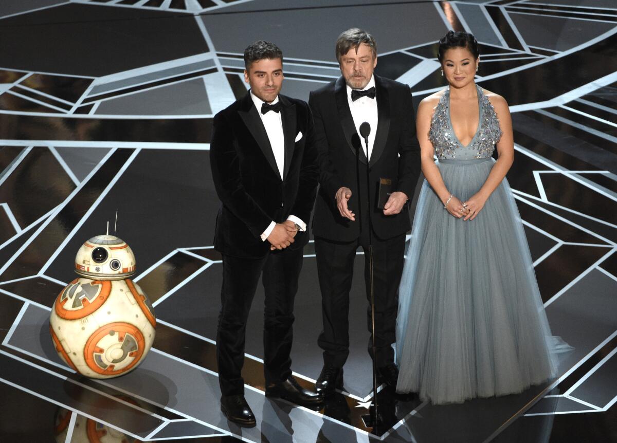 "Star Wars: The Last Jedi" actors Oscar Isaac, left, Mark Hamill and Kelly Marie Tran present at Sunday's Oscars.