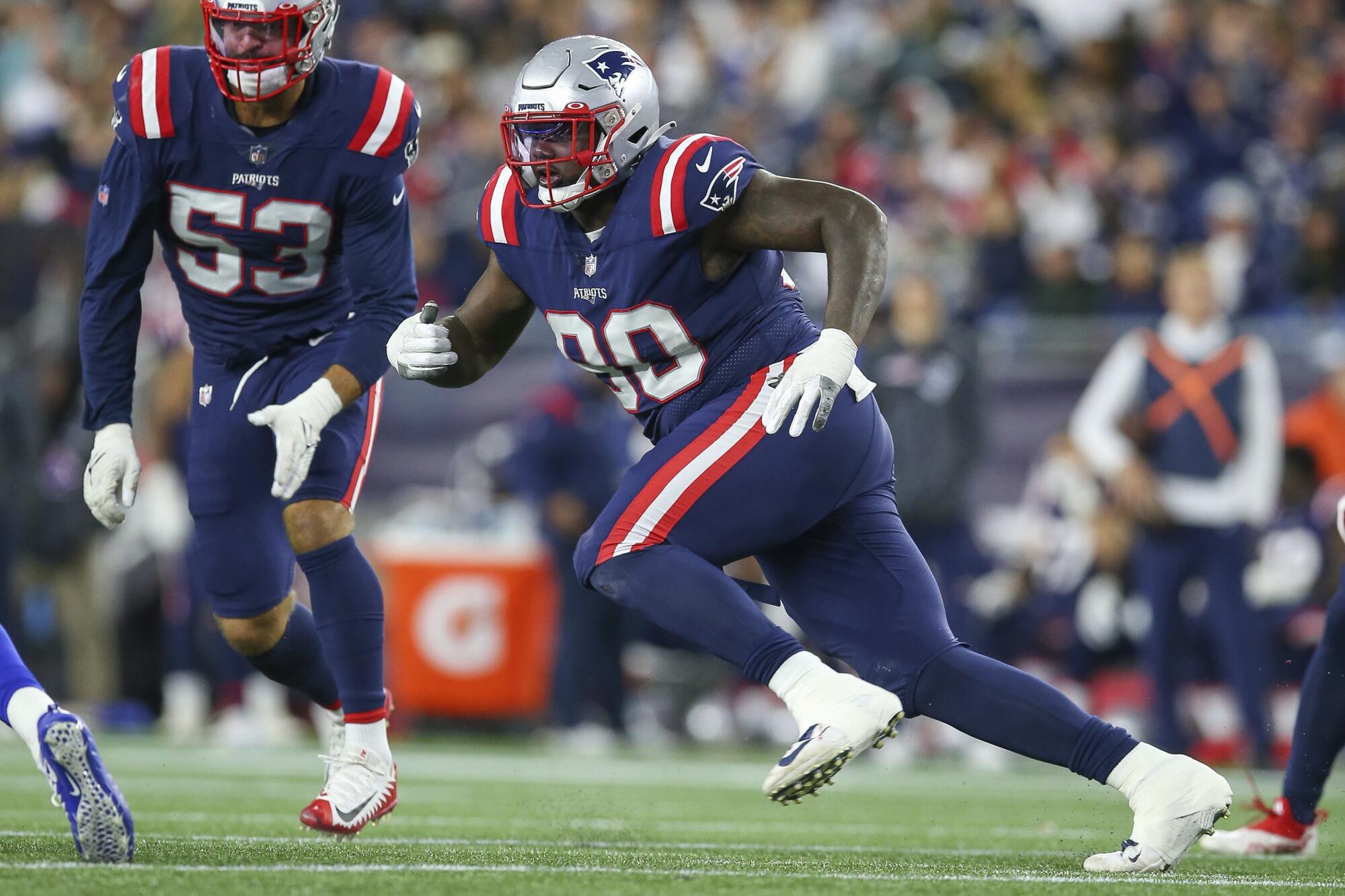 New England Patriots defensive tackle Christian Barmore defends.