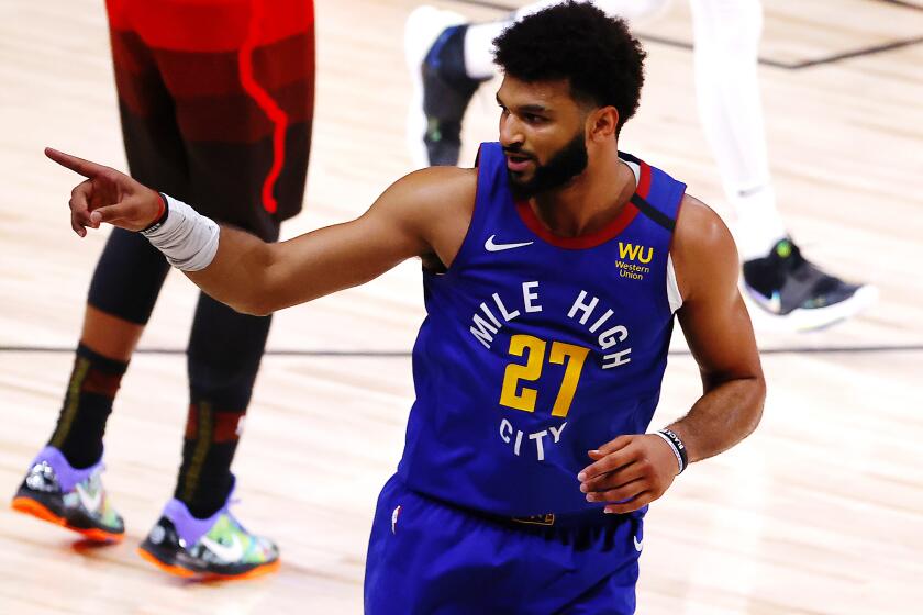 The Nuggets' Jamal Murray reacts after a three-pointer against the Jazz during double overtime Aug. 8, 2020.