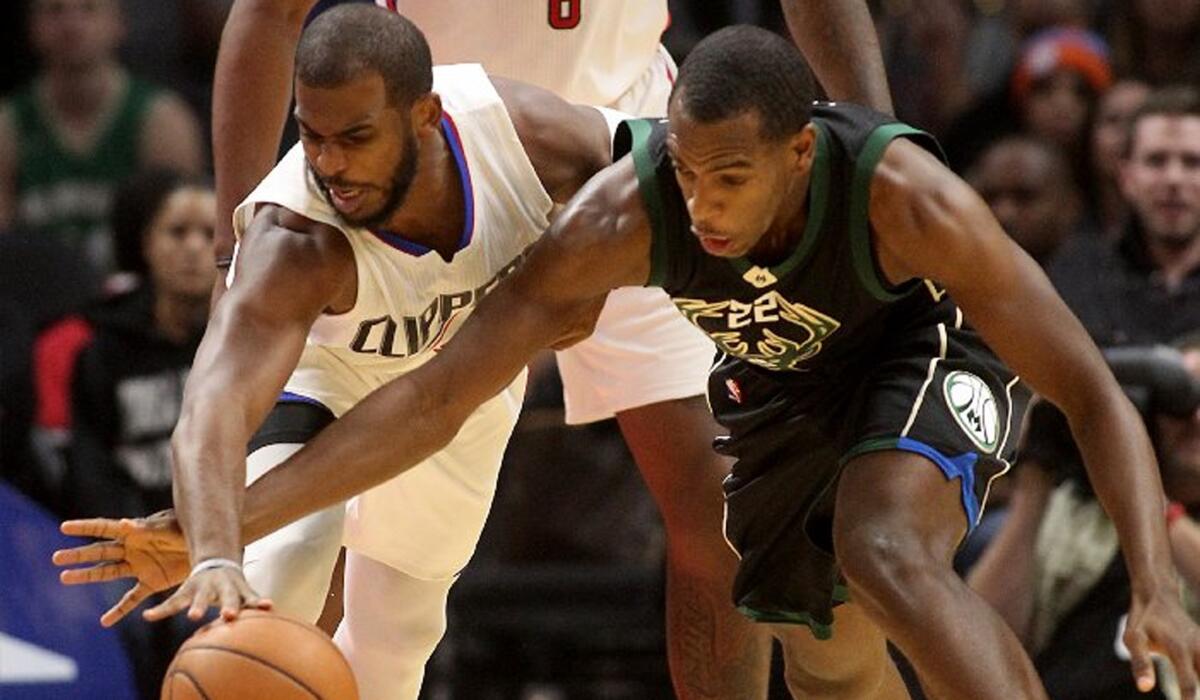 Clippers point guard Chris Paul steals the ball away from Bucks forward Khris Middleton in the first quarter.