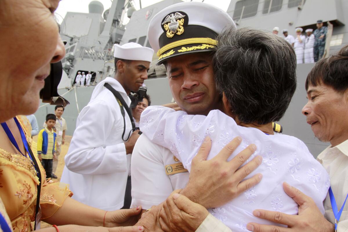 Cmdr. Michael Vannak Khem Misiewicz embraces his aunt at the port of Sihanoukville, Cambodia, in 2010.