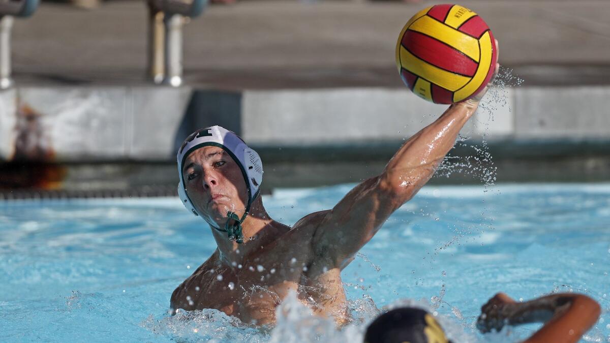 Caedmon Fisher, shown shooting against Estancia High on Oct. 24, 2018, scored 154 goals as a senior for the Costa Mesa boys' water polo team.