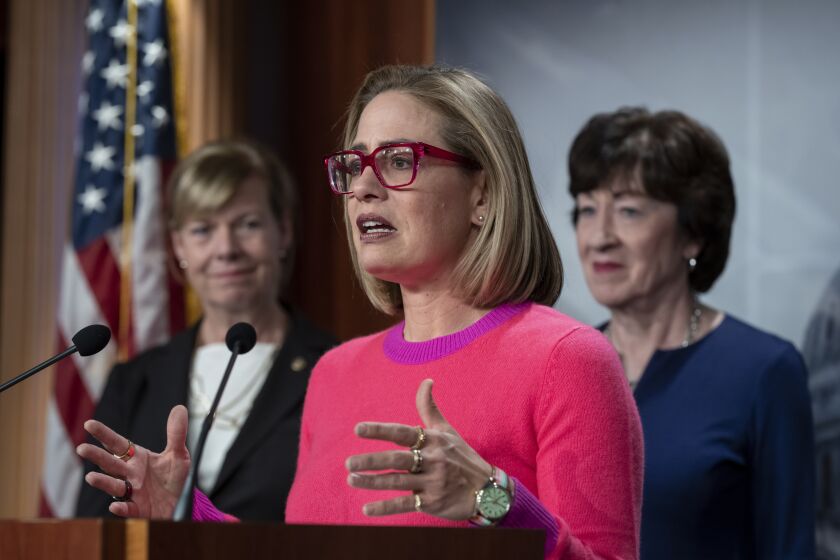 FILE—Sen. Kyrsten Sinema, D-Ariz., flanked by Sen. Tammy Baldwin, D-Wis., left, and Sen. Susan Collins, R-Maine, speak to reporters following Senate passage of the Respect for Marriage Act, at the Capitol in Washington, Tuesday, Nov. 29, 2022. Sen. Sinema announced on Friday, Dec. 9, 2022, that she has left the Democratic Party and registered as an independent. (AP Photo/J. Scott Applewhite, File)