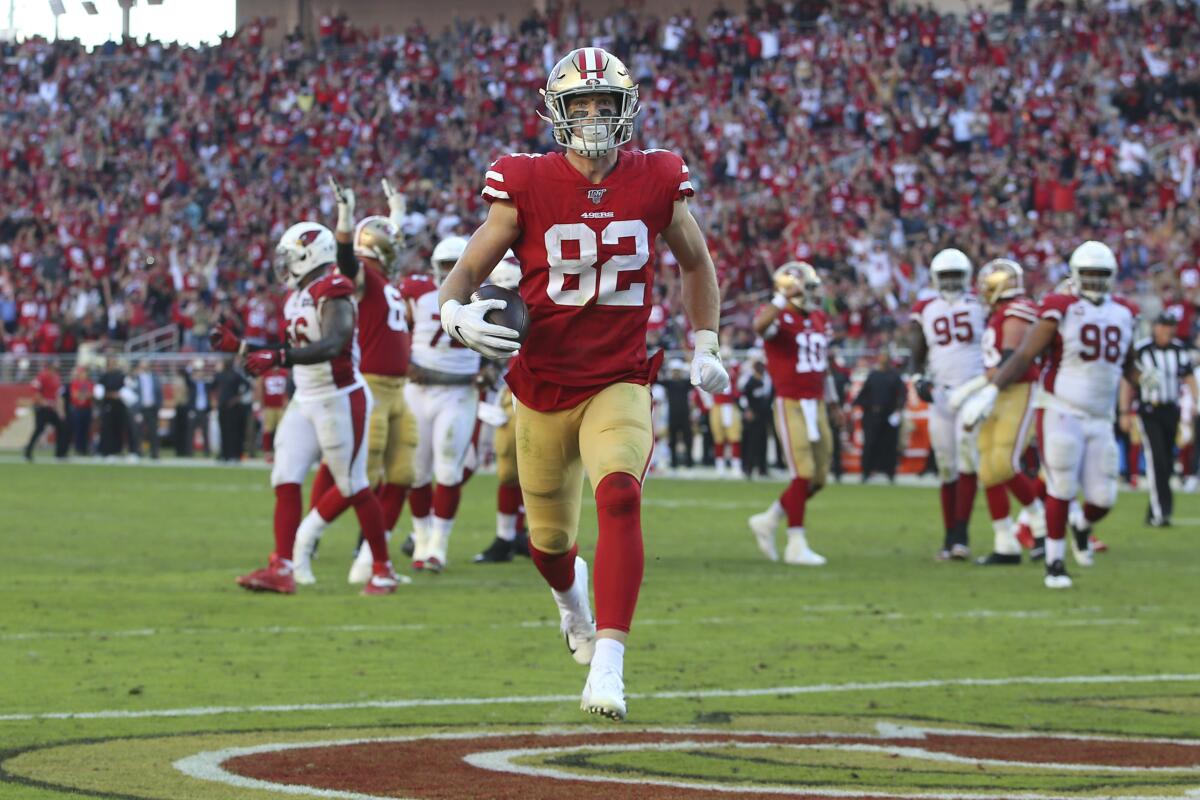 San Francisco 49ers tight end Ross Dwelley (82) scores against the Arizona Cardinals during the game on Sunday in Santa Clara.