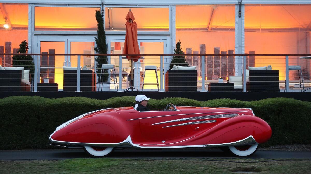 A 1938 Delahaye 165 Figoni & Falaschi Cabriolet from the Robert M. Lee Automobile Collection in Sparks, Nevada, drives into position at the 2016 Pebble Beach Concours d'Elegance.