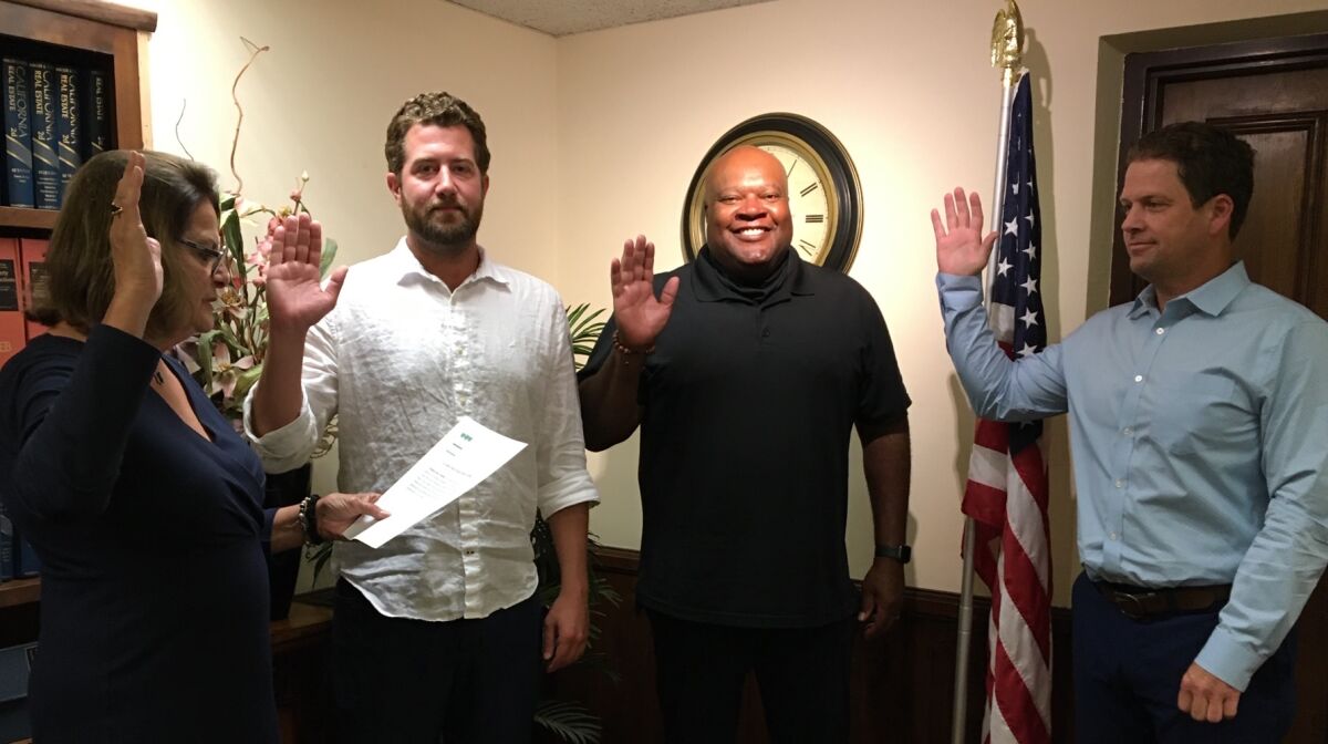 From left, Ann Kerr Bache swears in Rick Dagon, Tony Harris and James Rudolph as La Jolla Town Council trustees June 11.