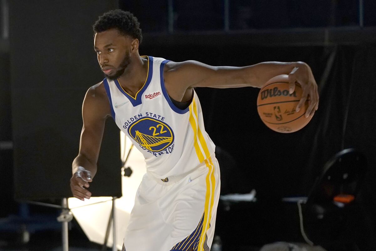 Golden State Warriors forward Andrew Wiggins poses for photos during the NBA basketball team's media day in San Francisco, Monday, Sept. 27, 2021. (AP Photo/Jeff Chiu)
