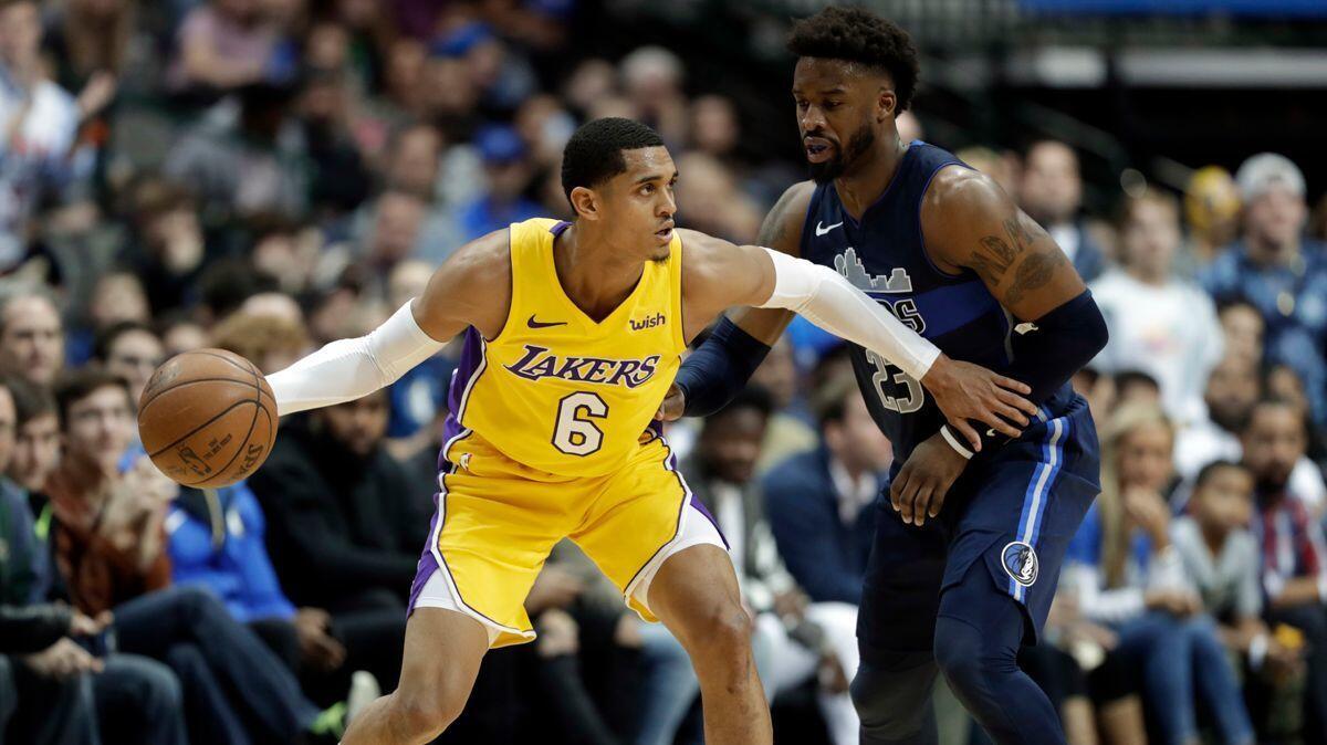 Lakers guard Jordan Clarkson (6) works against Dallas Mavericks' Wesley Matthews in the second half on Saturday.