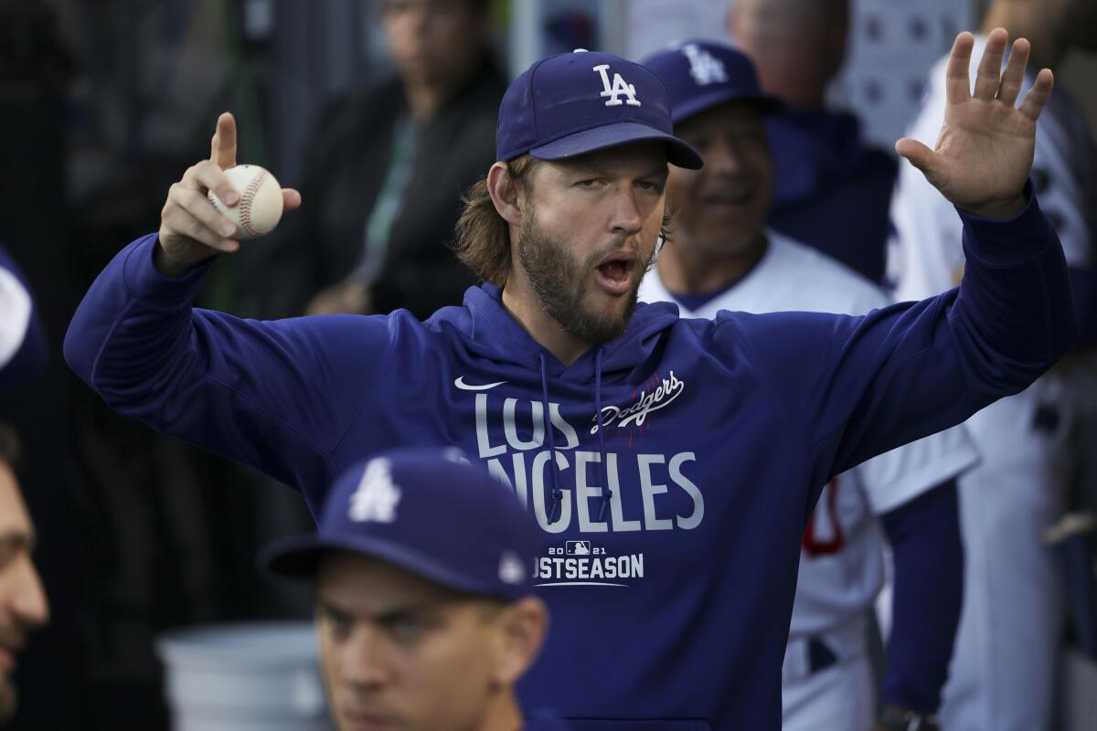 The Dodgers' Clayton Kershaw gestures while walking through the dugout before Game 4 of the 2021 NLDS on Oct. 12, 2021.