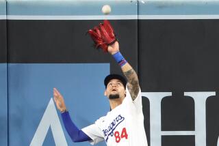 Dodgers center fielder Andy Pages makes a catch at the wall against the Nationals at Dodger Stadium Tuesday.